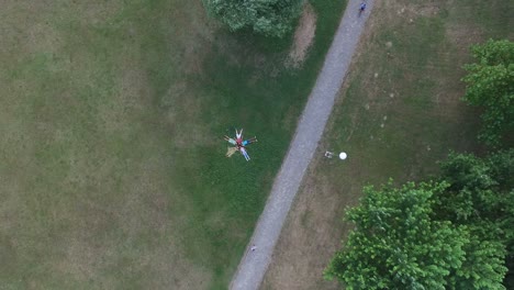 beautiful young friends forming a star shape lying in grass