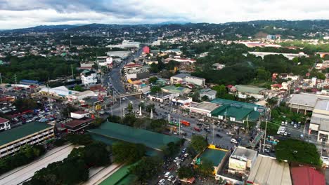 Stable-nice-view-of-landscpae-from-the-town-of-Taytay-Rizal,-Philippines,-the-long-busy-highway,-cloudy-sky-and-silhouetted-mountain-above