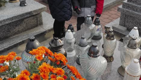 cemetery, people are standing by the grave