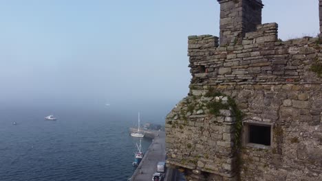 carrigaholt castle and harbour in a sea fog