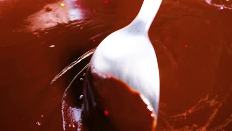 Spoon stirring smooth, rich chocolate mixture