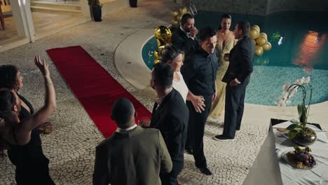 guests socializing at a luxurious poolside evening party