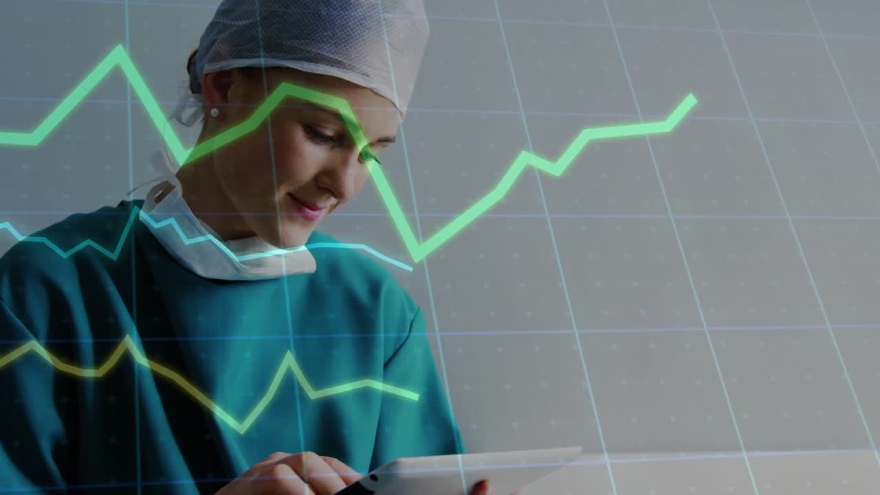 Clinician using tablet and swiping, showing grid overlay with green,yellow graphs monitoring data