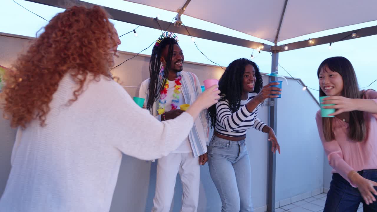 Group of friends celebrating birthday on the roof