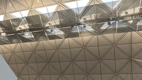 geometric ceiling with reflective surfaces and lighting