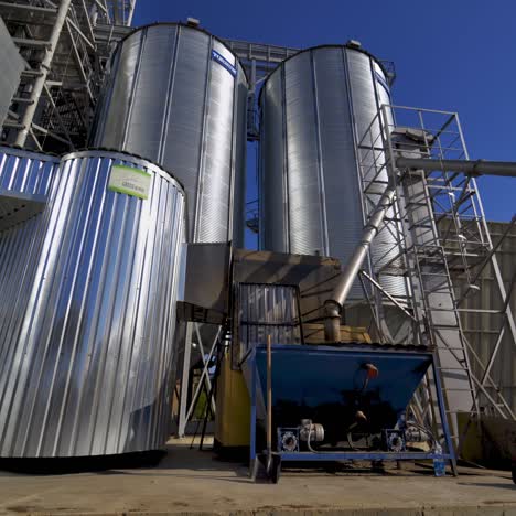exterior of industrial plant. modern construction of grain elevators outdoors. metal granary for storing crop. industrial equipment outdoors.