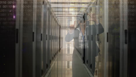 binary code over person photographing data center servers