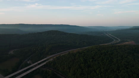 Highway-Bridge-Surrounded-With-Lush-Vegetation-Near-Lake-Fort-Smith,-Arkansas,-USA---aerial-shot