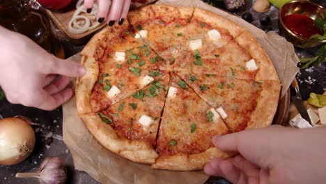 people takes from table slices of fresh italian pizza.