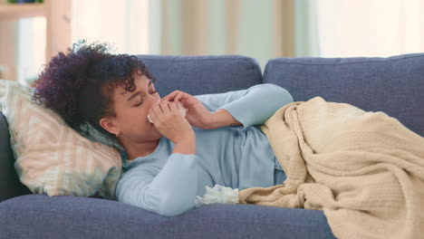 Woman-sick-with-the-flu-on-a-couch-at-home