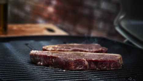 steaks being cooked on a flaming hot bbq grill and sizzling