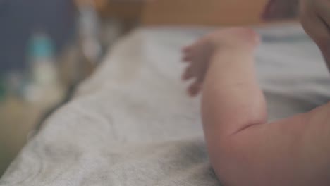 professional-pediatrician-massages-newborn-boy-on-table