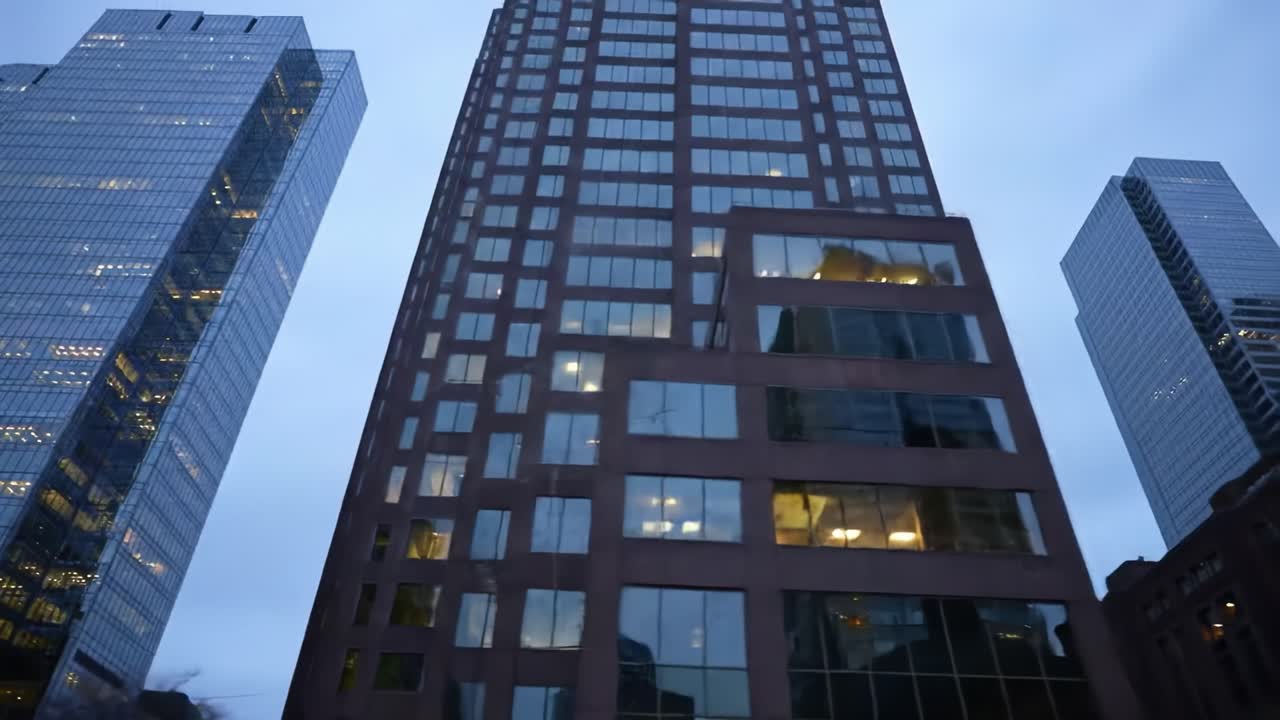 Skyscrapers Towering in Twilight: Capturing the Urban Landscape with Reflected Lights and Modern Architecture Amidst a Cloudy Evening Sky