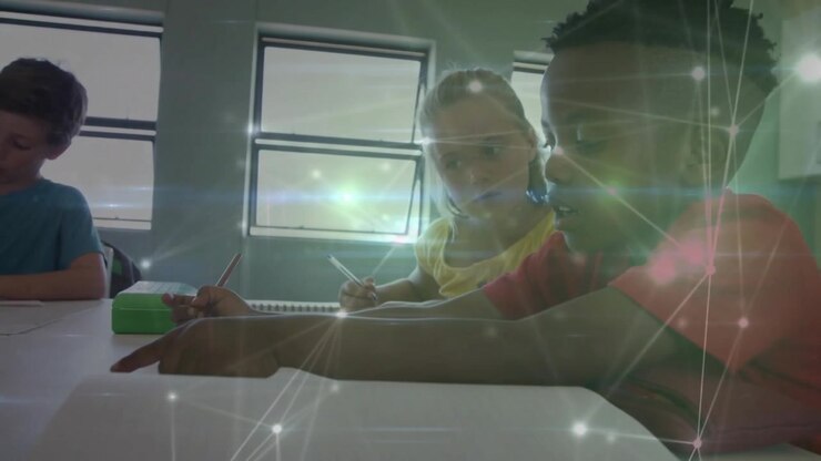 Boy in red pointing at worksheet, explaining problem, girl writing under classroom network overlay