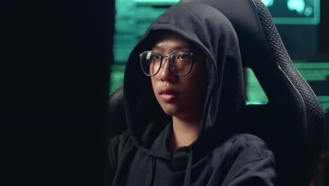 asian boy hacker using computer hacking and celebrating