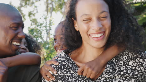 Outdoor-Portrait-Of-Multi-Generation-Family-In-Garden-At-Home-Against-Flaring-Sun