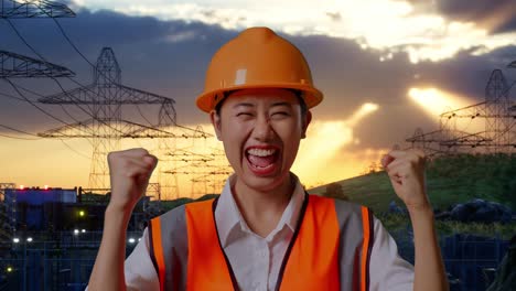 primer plano de ingeniera asiática con casco de seguridad gritando meta celebrando trabajando cerca de la torre de alto voltaje