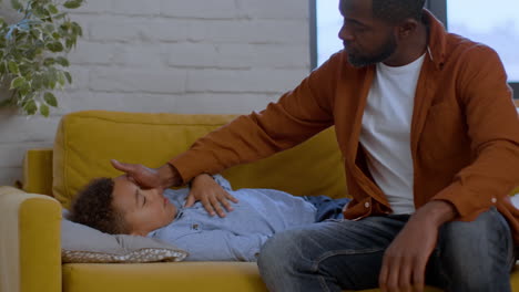 father checking on sick son