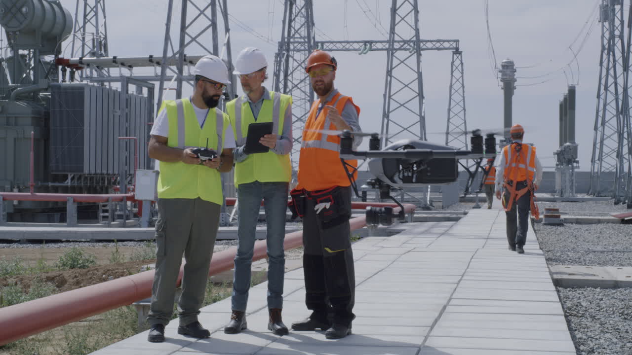 Power Plant Workers Inspecting with Drones