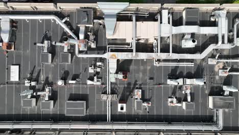 drone top down pan left above ventilation piping and network cooling flow of electrical systems