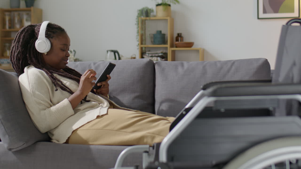 Black with Disability Enjoying Music on Phone