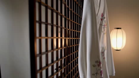 white kimono hanging in a traditional japanese room