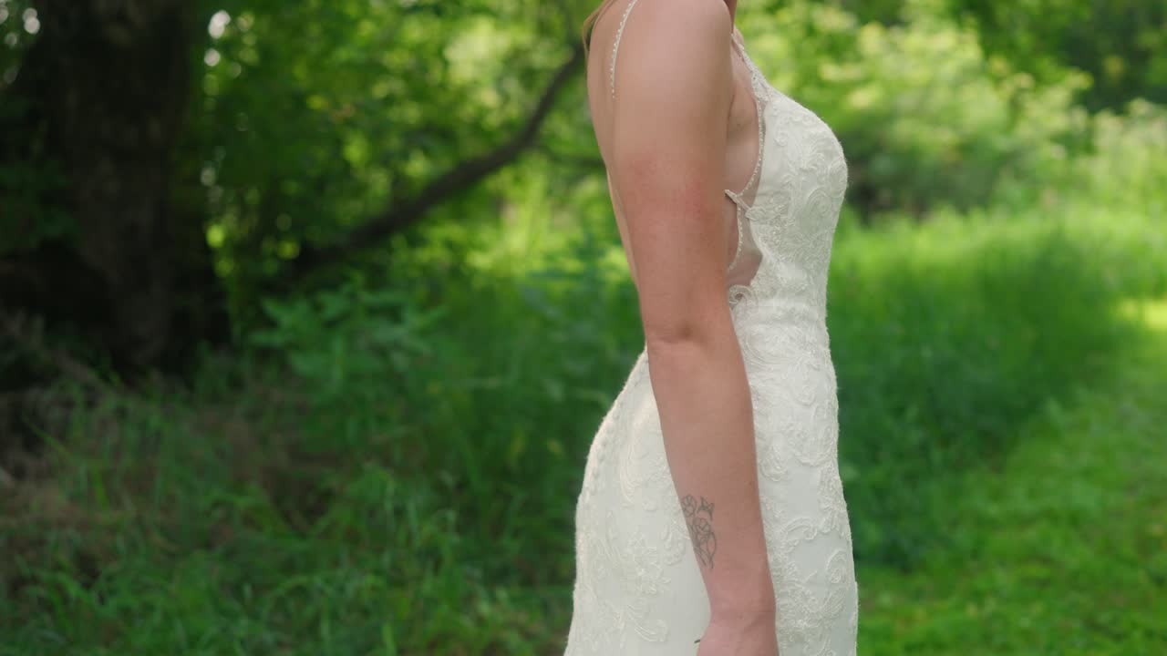 Bride Posing in Forest Holding Bouquet as Camera Moves Up in Slow Motion