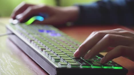 young gamer plays a video game uses gaming illuminated keyboard 02