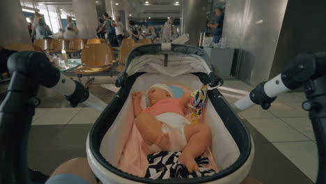 Dad-with-baby-in-pram-waiting-at-the-airport