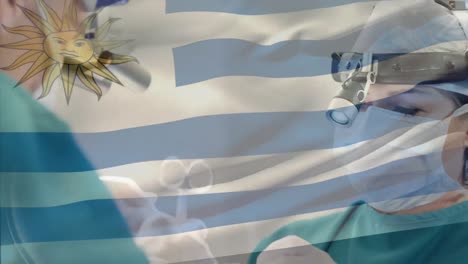 Animation-of-flag-of-uruguay-waving-over-surgeons-in-operating-theatre