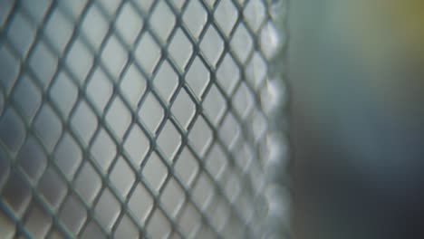 a hyper macro shot of a metal grid, steel pattern, iron industrial texture, aluminum material, super slow motion, full hd 120 fps, slide up smooth movement