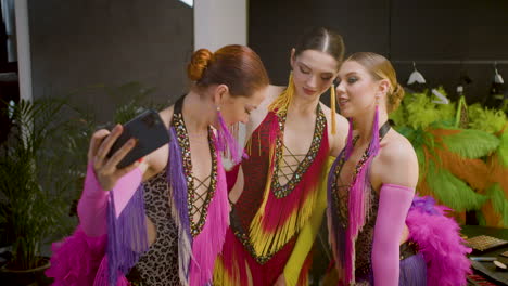 pretty female dancers taking selfie before the show