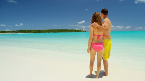 caucasian couple in swimwear at caribbean beach resort