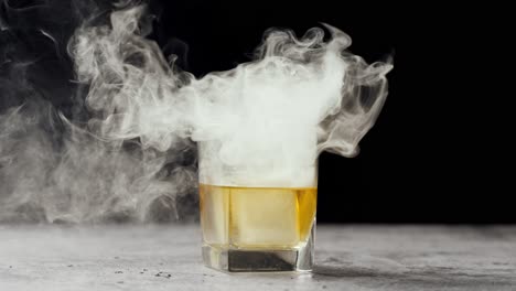 speed ramp video of smoke rolling off of whiskey cocktail