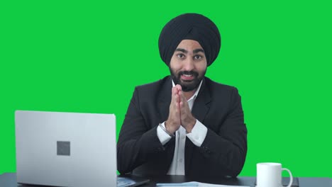 Happy-Sikh-Indian-businessman-talking-to-someone-Green-screen