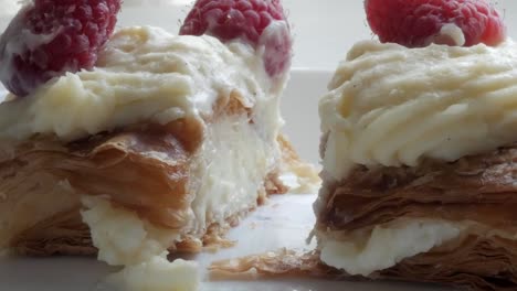 flaky millefeuille pastry with creamy filling topped with fresh raspberries