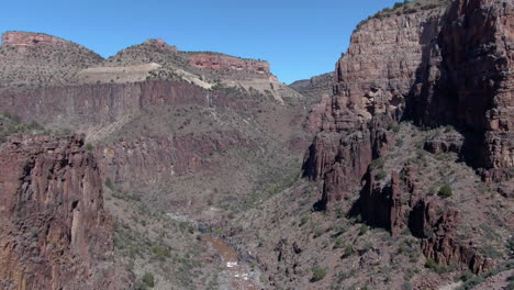 drone shot flying in middle of a steep canyon, in sunny superior, arizona, usa