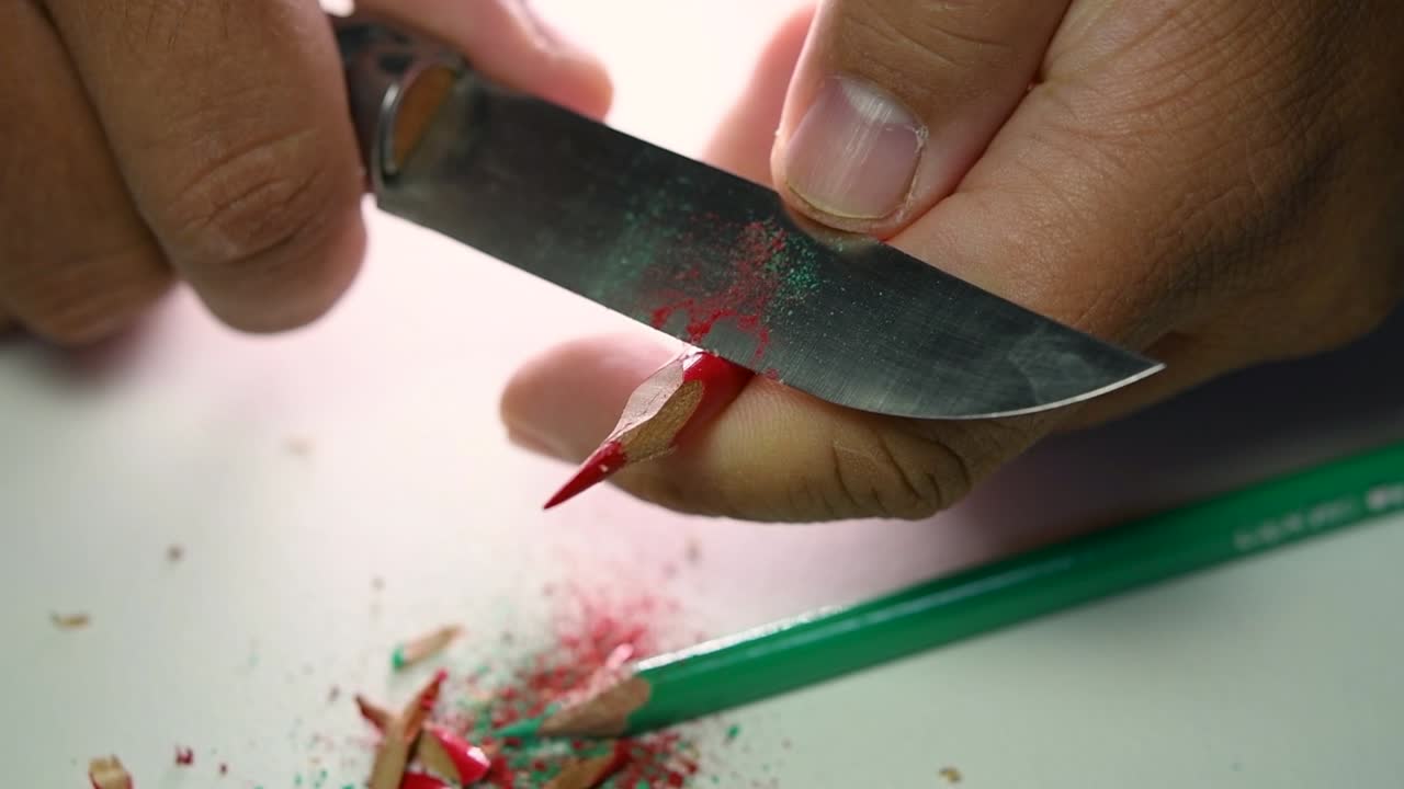 imágenes de manos afilando lentamente un lápiz y algunos lápices de colores con un cuchillo afilado
