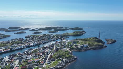 Wide overview of Henningsvaer islands in Lofoten with open sea horizon on bright summer day