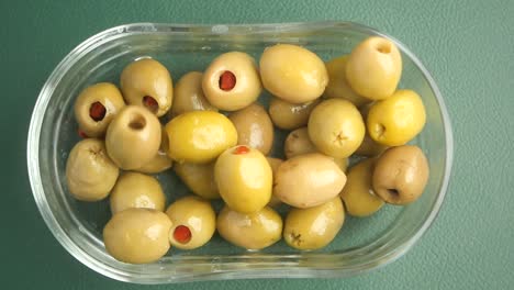 stuffed green olives in a glass bowl