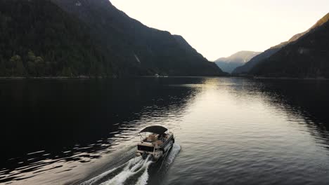 Aerial-drone-shot-of-boat-in-Indian-Arm,-an-ocean-in-Vancouver,-Canada