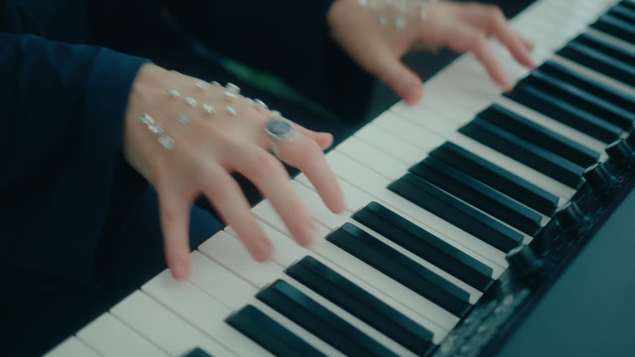 Hands of Female Musician Decorated with Gems Playing Keyboard