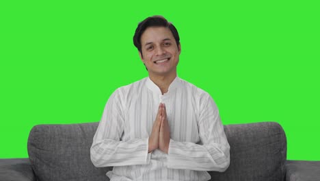 happy indian man doing namaste green screen