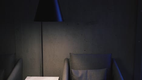 dramatic looking chair next to a lamp and a white table