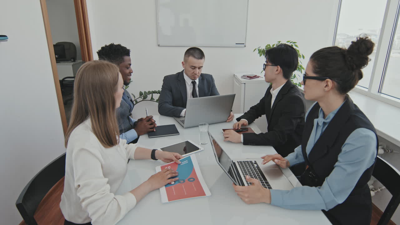 CEO in Wheelchair Entering Meeting Room and Greeting Colleagues