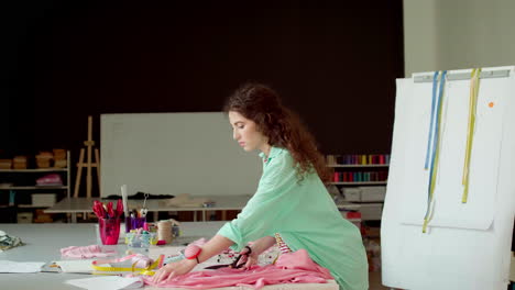 dressmaker cutting fabric.