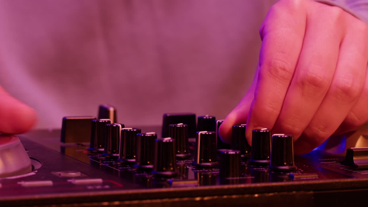 DJ with headphones and sunglasses playing music on festival in night club. Techno musician performing at nightclub for concert crowd of people, city bar.