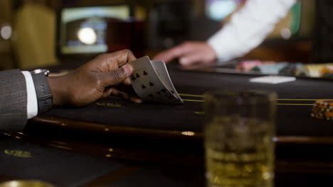 man looking at his hand of cards.