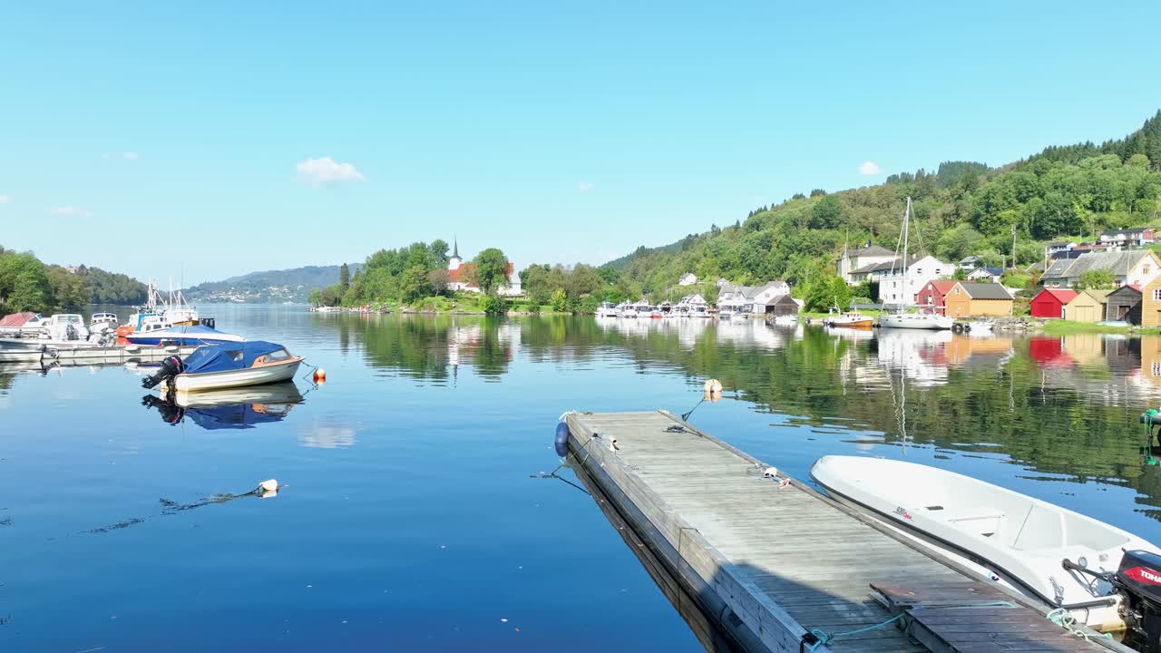 Three seniors enjoying lunch and beer with a stunning fjord view in Osteroy, Norway. Clip rises to reveal the landscape