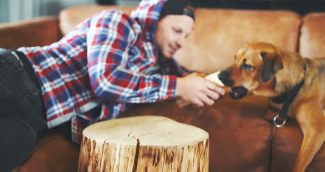 man having fun with dog at home